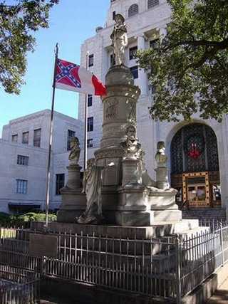 Caddo Courthouse monument with the Third National Flag of the Confederate States of America, aka “the Blood-Stained Banner.”